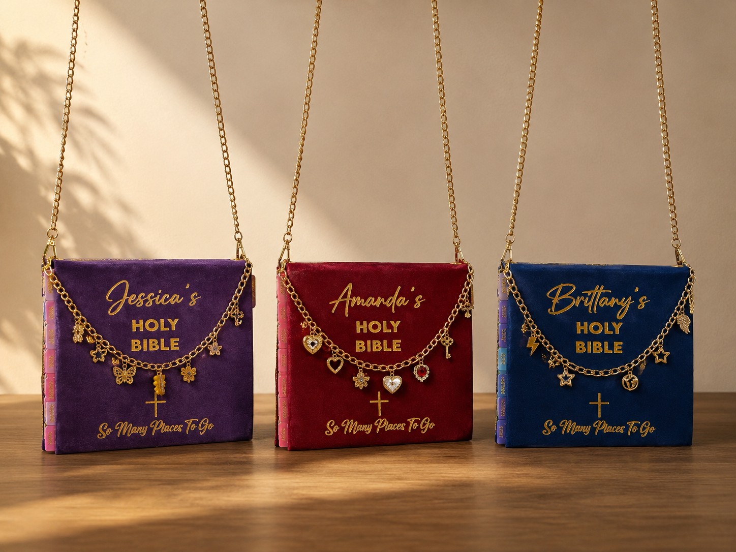 Three H.E.R. Word Bags in purple, red and navy velvet with personalized gold charm chains