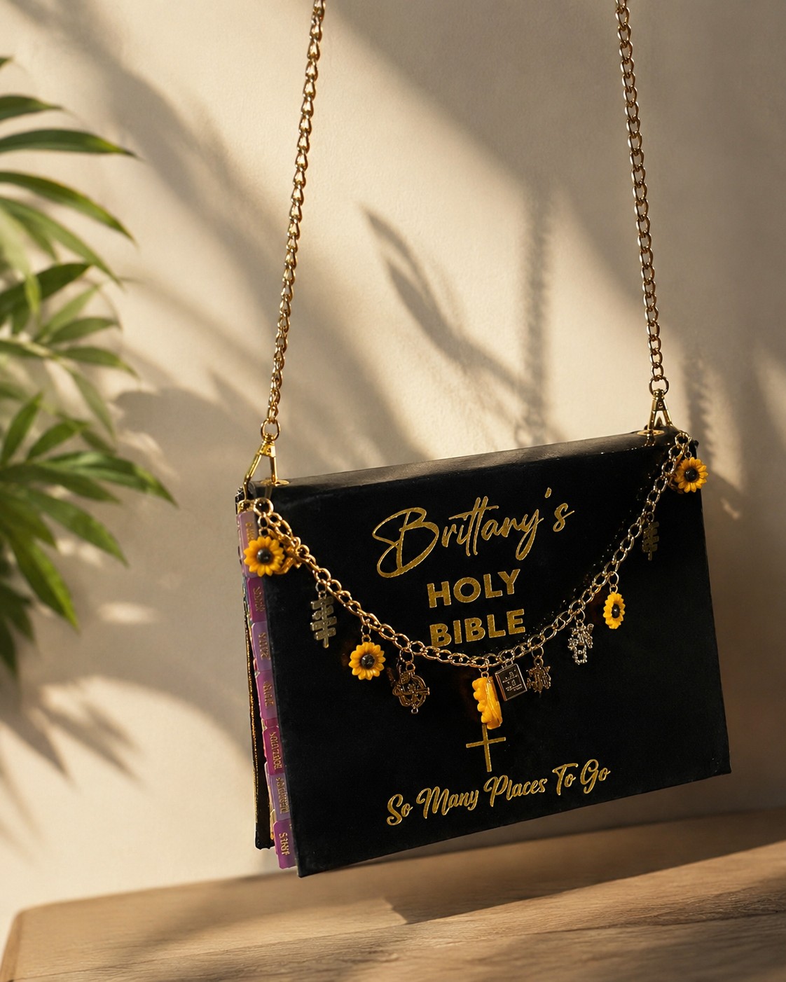 Black velvet Bible purse with sunflower and cross charms on a gold chain